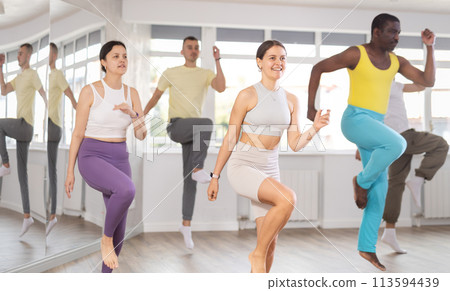 Young woman practicing aerobic dance in training hall 113594439