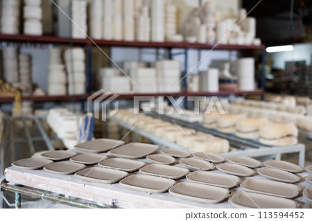 Abundance of crafted plates on shelf in ceramic workshop Abundance of crafted plates on shelf in ceramic workshop 113594452