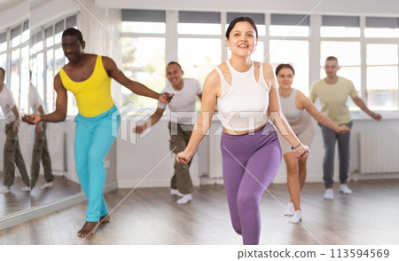 Young Asian woman practicing hip-hop dance in training hall 113594569