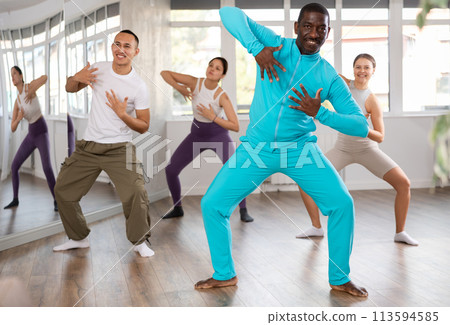 African man with team of like-minded multinational people learn to elements of contemporary dance African man with team of like-minded multinational people learn to elements of contemporary dance 113594585