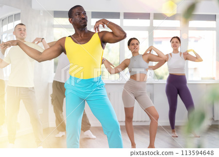 African man with team of like-minded multinational people learn to elements of contemporary dance African man with team of like-minded multinational people learn to elements of contemporary dance 113594648