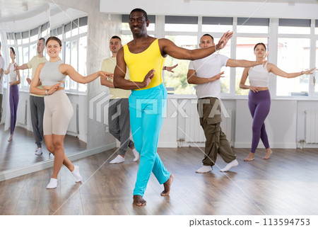 African man with team of like-minded multinational people learn to elements of contemporary dance African man with team of like-minded multinational people learn to elements of contemporary dance 113594753