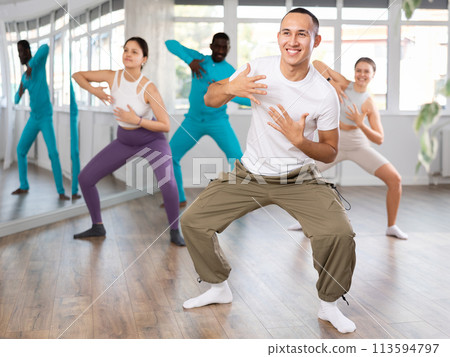 Expressive Asian guy honing hip-hop dance moves in studio Expressive Asian guy honing hip-hop dance moves in studio 113594797