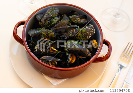 Steamed mussels served on table with piece of lemon Steamed mussels served on table with piece of lemon 113594798