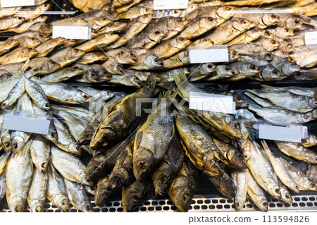 Cured herring and other fish in supermarket 113594826