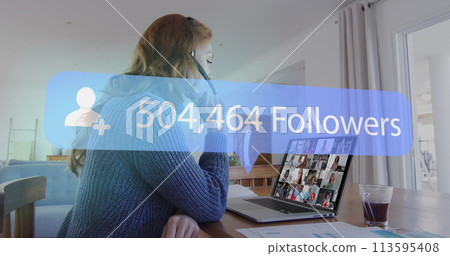 Image of speech bubble with number of followers growing over woman using laptop on image call Image of speech bubble with number of followers growing over woman using laptop on image call 113595408