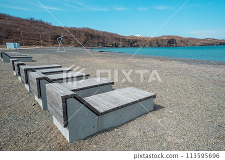 wooden sun loungers on the beach Ahlestisheva in Russky island, Vladivostok 113595696