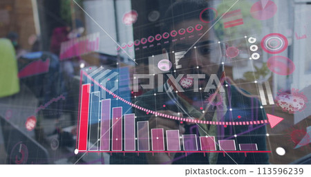 Image of statistics recording and covid 19 cells over man drawing in office wearing face mask 113596239
