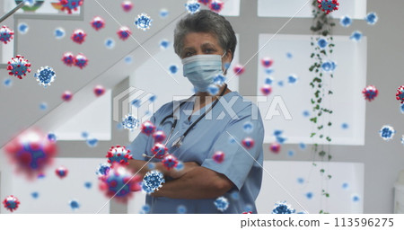 Image of covid 19 cells over female doctor wearing face mask Image of covid 19 cells over female doctor wearing face mask 113596275