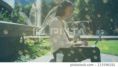 Image of bitcoin icons over woman using laptop in park Image of bitcoin icons over woman using laptop in park 113596282