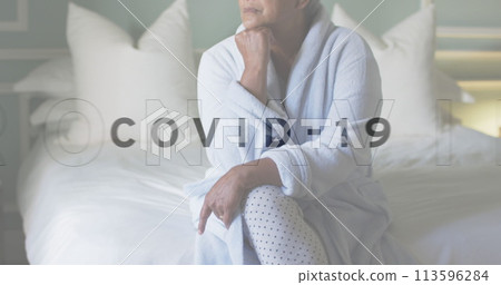 Image of covid 19 text over sad senior woman 113596284