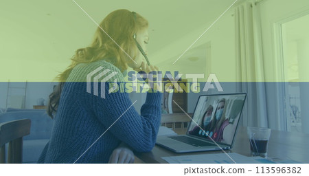 Image of social distancing text over woman using laptop on image call Image of social distancing text over woman using laptop on image call 113596382