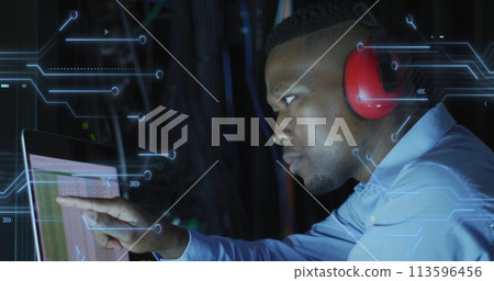 Image of integrated circuits over african american man working on laptop 113596456