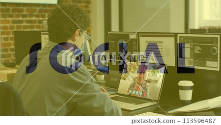 Image of social distancing text over man in face mask using laptop on image call 113596487