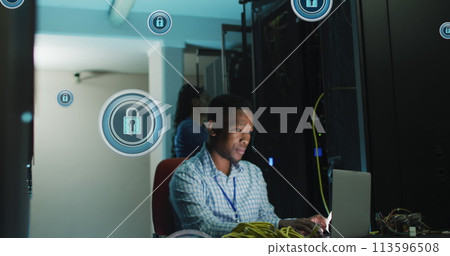 Image of digital padlocks over african american man working on laptop in server room 113596508