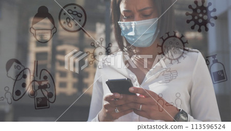 Image of covid 19 icons over woman using smartphone wearing face mask Image of covid 19 icons over woman using smartphone wearing face mask 113596524