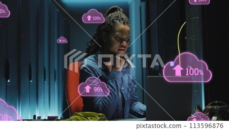 Image of cloud with uploading over african american woman working on laptop in server room 113596876