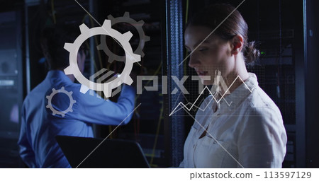 Image of graphs and data over caucasian woman working in server room 113597129