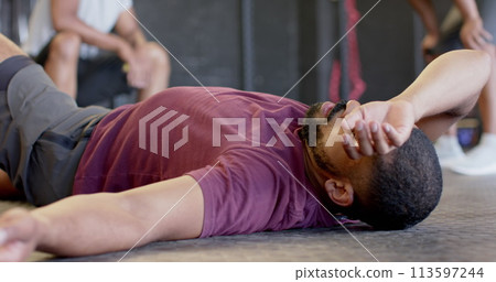 Image of social media notifications over biracial man relaxing after training at gym 113597244