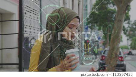 Image of connected social media icons with woman wearing hijab drinking coffee in street 113597433