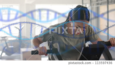 Image of dna strands over caucasian woman cross training on elliptical at gym 113597436