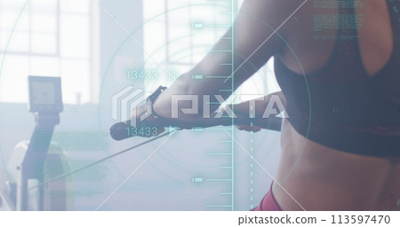 Image of processing data over biracial woman training on rowing machine at gym 113597470