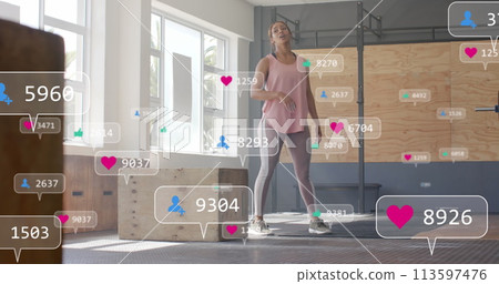 Image of social media notifications over tired caucasian woman after training at gym Image of social media notifications over tired caucasian woman after training at gym 113597476
