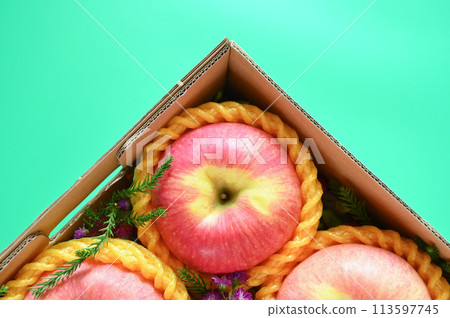 beautiful pink apple in the box on green background beautiful pink apple in the box on green background 113597745