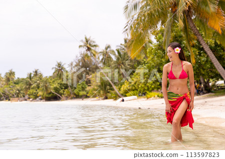 French Polynesia video of woman wearing traditional pareo and Bikini relaxing on perfect beach on Bora Bora. French Polynesia Beach Vacation Travel 113597823