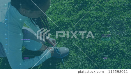 Image of statistics and graphs over woman tying her shoes on grass 113598011
