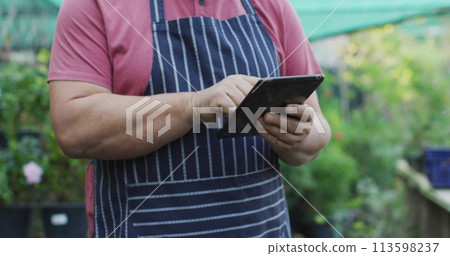 Image of network of connections with icons over caucasian man using tablet 113598237