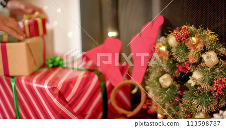 Hands of a person wrapping gifts for the festive season at home 113598787