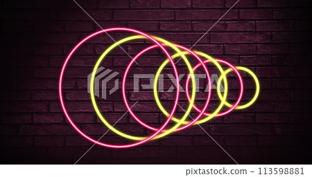 Image of neon circles over dark red brick wall 113598881