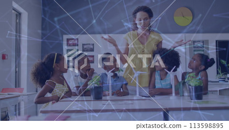 Image of network of connections over happy diverse female teacher and pupils with wind turbines 113598895