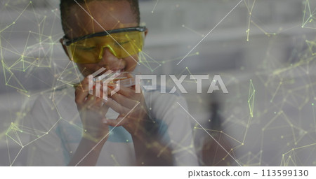 Image of networks over happy african american schoolboy studying petri dish in science class Image of networks over happy african american schoolboy studying petri dish in science class 113599130