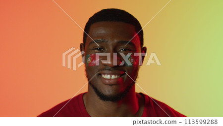 Image of african american male supporter with flag of portugal over shapes Image of african american male supporter with flag of portugal over shapes 113599288