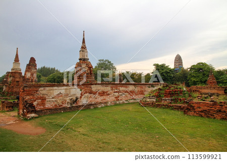 Ayutthaya, the ancient capital of Thailand, a World Heritage Site; the ruins of Wat Mahathat temple, famous for the head of a Buddha statue buried among the roots 113599921