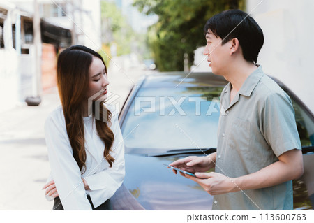 Young Asian female driver talking with car accident claim representative on the road, feeling stressed and concerned Young Asian female driver talking with car accident claim representative on the road, feeling stressed and concerned 113600763