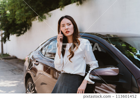 Young asian female driver calling a car insurance company representative about accident claim process, feeling stressed and worried 113601452