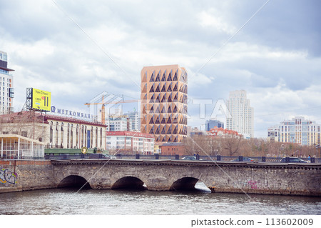 Headquarters of Russian copper company by architect Norman Foster and Iset river bridge. red brown pineapple skyscraper. Copper House building Yekaterinburg, Russia 5.5.23 113602009