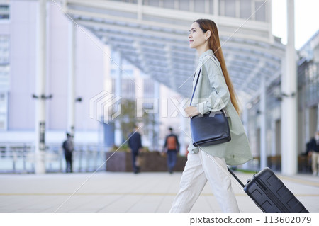 Female inbound foreign traveler traveling with a suitcase 113602079