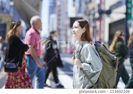 Female inbound backpacker walking with a backpack 113602106