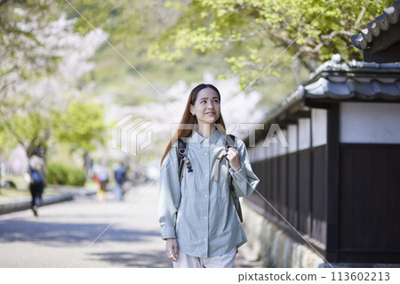 Inbound female traveler walking through a tourist spot in spring 113602213