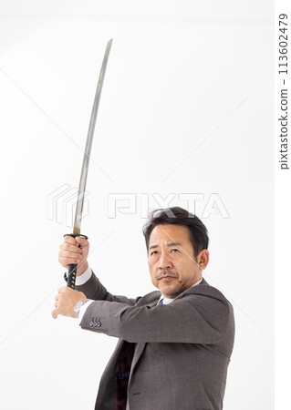 A man in a suit holding a sword A man in a suit holding a sword 113602479
