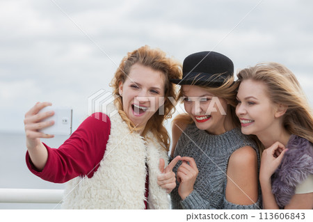 Three women taking selfie outdoor Three women taking selfie outdoor 113606843