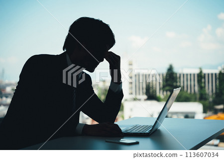 Silhouette of an office worker doing desk work (worry, trouble, stress, shock, mistake) Silhouette of an office worker doing desk work (worry, trouble, stress, shock, mistake) 113607034