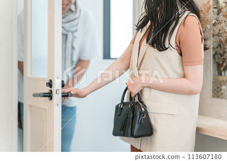 A man who is a hairdresser/stylist seeing a woman off as she comes out of a beauty salon (hair styling, perm, curl) 113607180