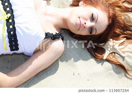 The beautiful girl lies on sea coast with shells nature vacation 113607284