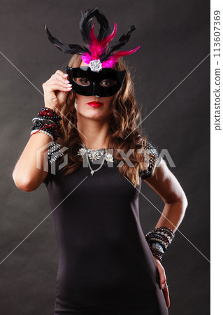 Woman with carnival venetian mask on dark Woman with carnival venetian mask on dark 113607369