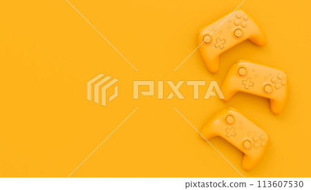 Video game joysticks or gamepads in plain monochrome yellow color background 113607530
